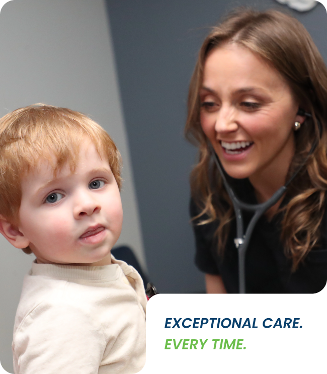 Pediatric doctor smiling while examining a young child with a stethoscope, conveying friendly and compassionate care.
